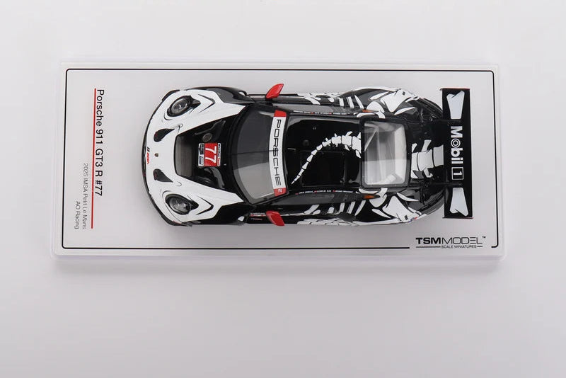A pre-order listing for a TSM Model Porsche 911 Carrera S 877 scale diecast model car. The car is shown inside its clear plastic blister packaging, featuring a black and white livery with red accents, including a prominent 'Mobil 1' sponsor logo.